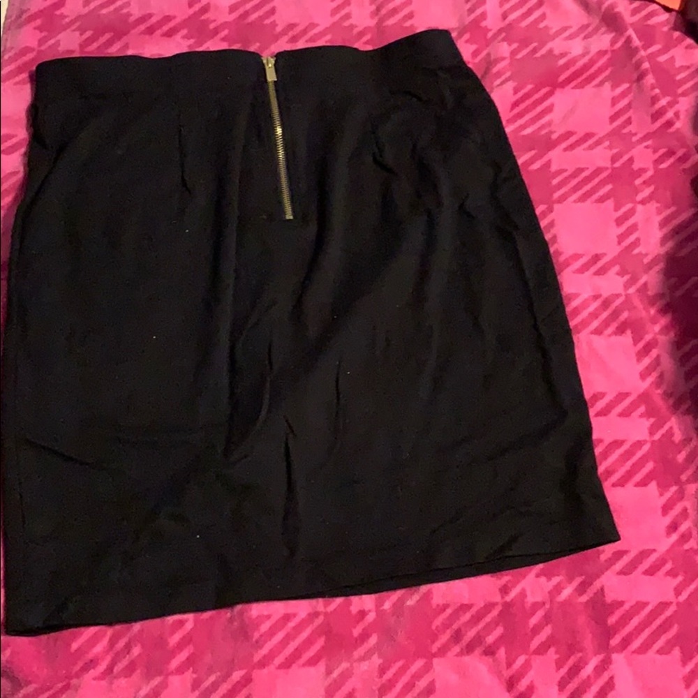 Black mini skirt with gold zipper detail on back